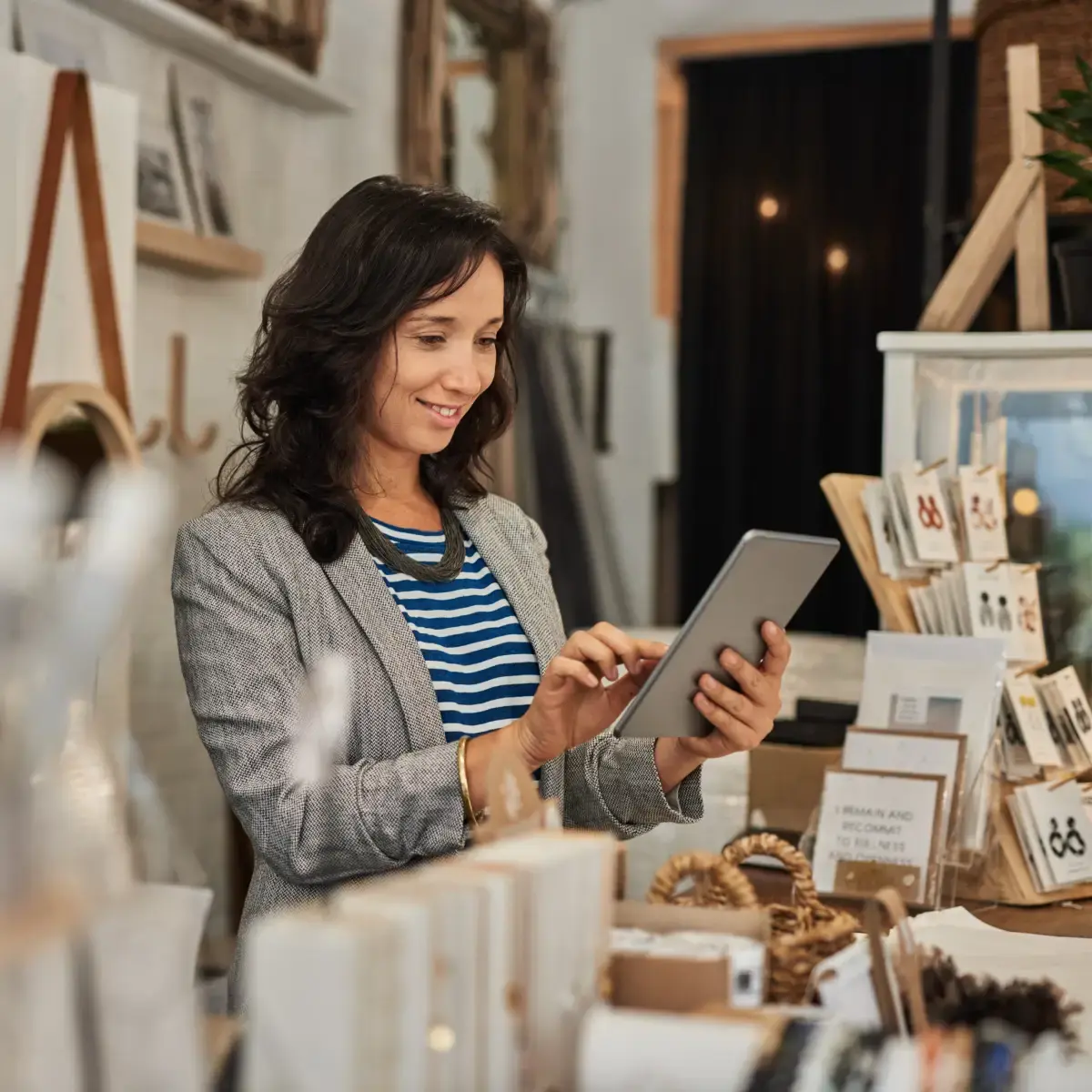 a business woman stands amongst her wares